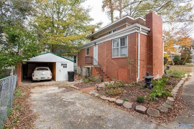 view of home's exterior with an outdoor structure and a garage