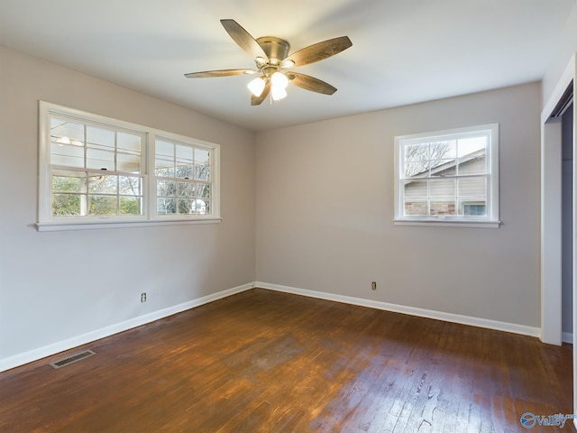 empty room featuring dark hardwood / wood-style floors and ceiling fan