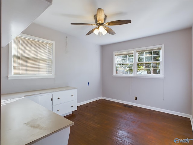 spare room with ceiling fan and dark hardwood / wood-style flooring