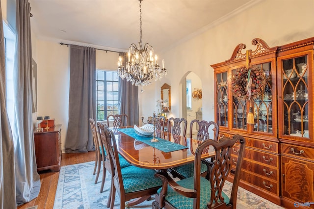 dining space with hardwood / wood-style flooring and crown molding