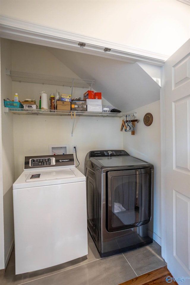 washroom featuring washing machine and dryer and hardwood / wood-style flooring