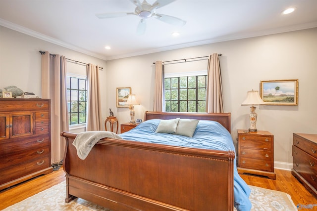 bedroom with light hardwood / wood-style flooring, ceiling fan, and crown molding