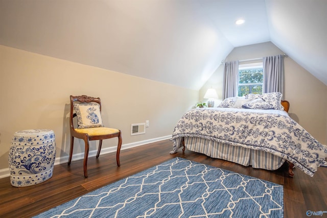 bedroom featuring dark wood-type flooring and lofted ceiling