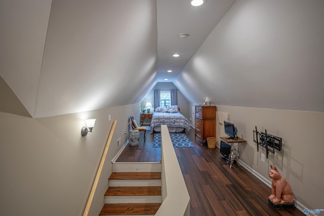 unfurnished bedroom featuring vaulted ceiling and dark hardwood / wood-style flooring