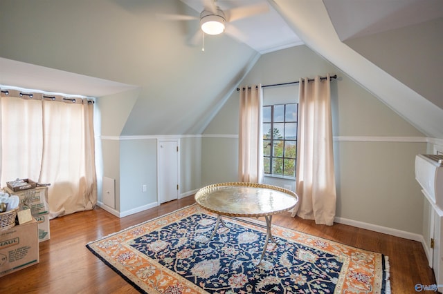 interior space featuring wood-type flooring, vaulted ceiling, and ceiling fan