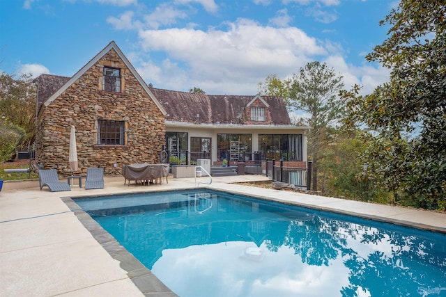 view of swimming pool featuring a patio area