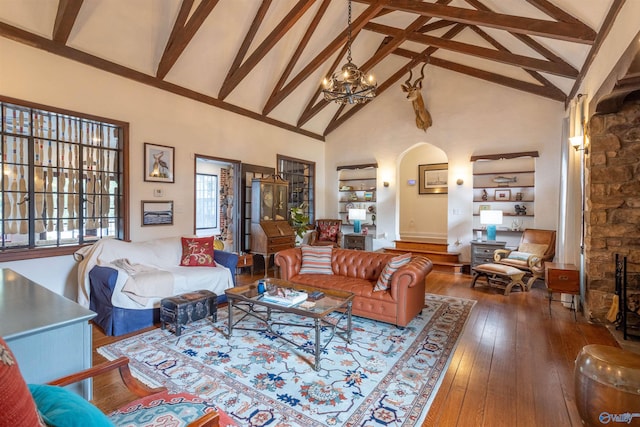 living room with high vaulted ceiling, a chandelier, wood-type flooring, and beam ceiling