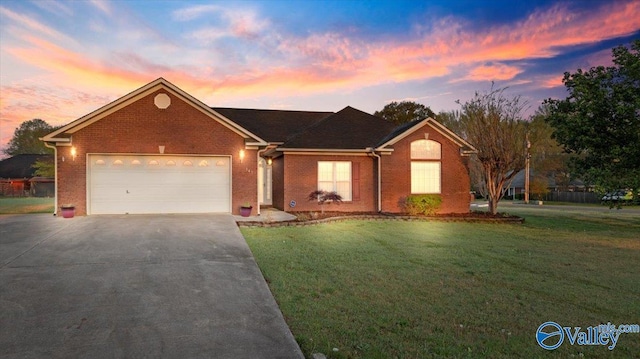 147 Singletree Dr, Hazel Green, AL 35750 - ranch-style house featuring concrete driveway, a front yard, a garage, and brick siding