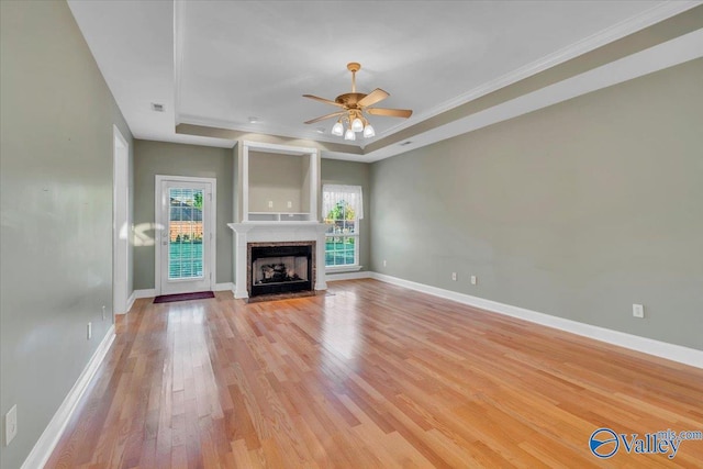 147 Singletree Dr, Hazel Green, AL 35750 - unfurnished living room featuring light wood-type flooring, baseboards, a ceiling fan, and a raised ceiling