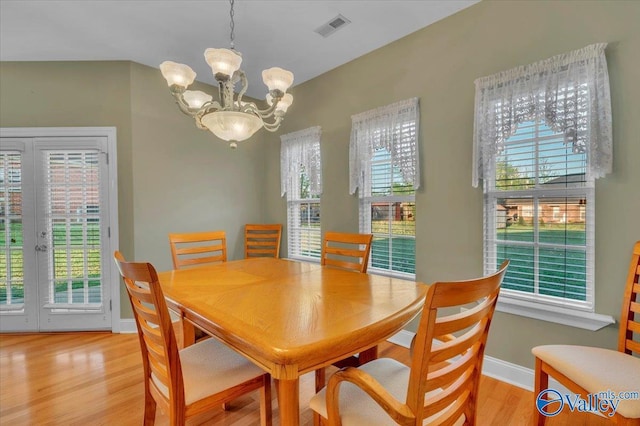 147 Singletree Dr, Hazel Green, AL 35750 - dining room featuring baseboards, light wood-type flooring, an inviting chandelier, french doors, and visible vents