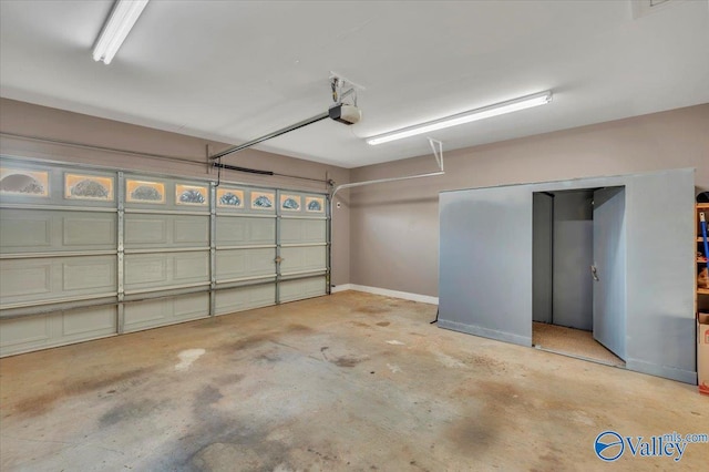 147 Singletree Dr, Hazel Green, AL 35750 - garage featuring a garage door opener and baseboards