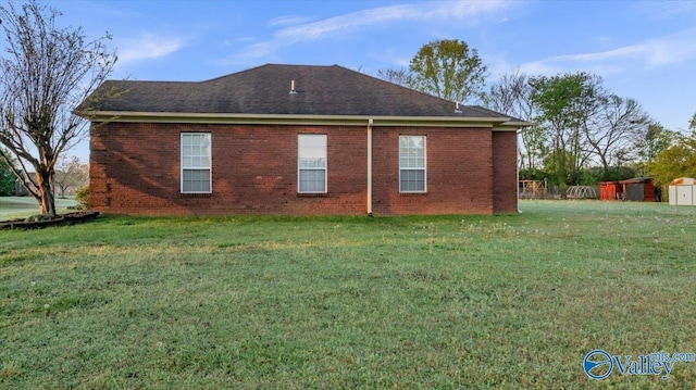 147 Singletree Dr, Hazel Green, AL 35750 - back of house with a yard, a shingled roof, and brick siding