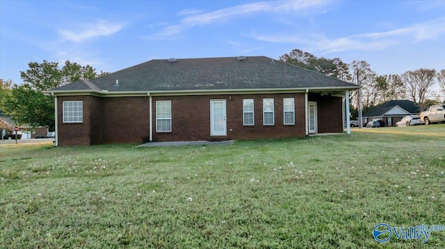 147 Singletree Dr, Hazel Green, AL 35750 - back of property featuring roof with shingles, a yard, and brick siding