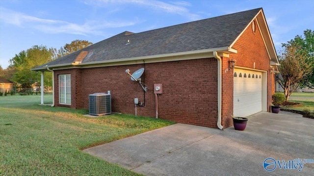 147 Singletree Dr, Hazel Green, AL 35750 - view of home's exterior featuring central air condition unit, brick siding, driveway, and a lawn