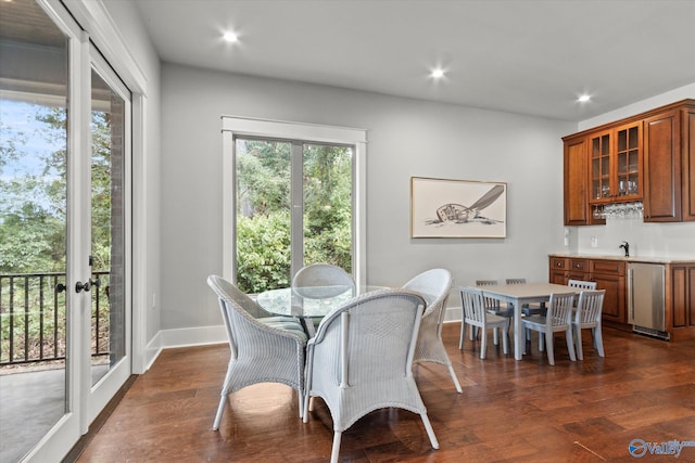 dining space featuring sink and dark hardwood / wood-style flooring