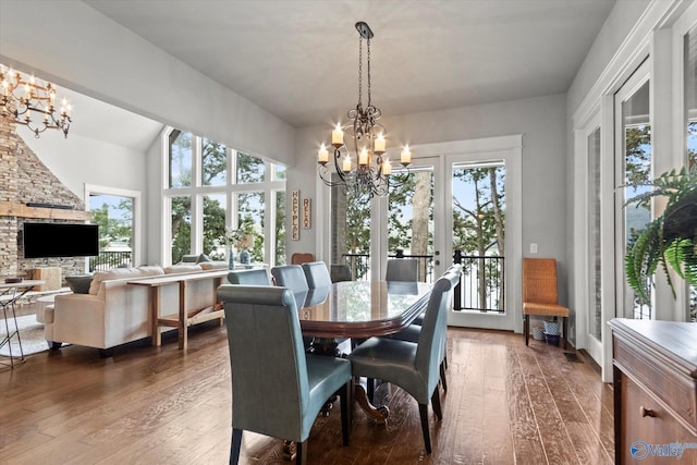 dining area featuring an inviting chandelier and dark wood-type flooring