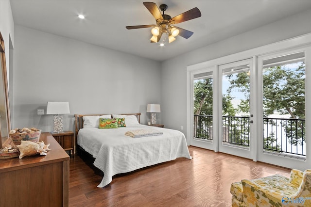 bedroom featuring ceiling fan, wood-type flooring, and access to outside