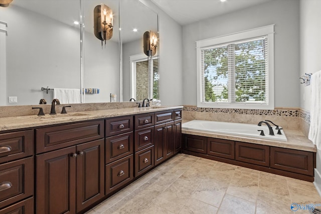 bathroom featuring vanity and a bath