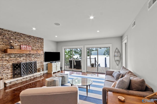 living room featuring a stone fireplace