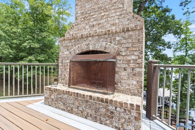 deck featuring an outdoor brick fireplace