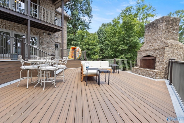 wooden deck featuring an outdoor living space with a fireplace