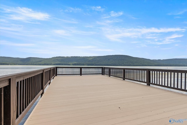 view of dock featuring a water and mountain view