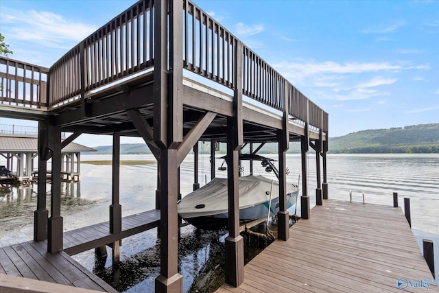 view of dock featuring a water and mountain view