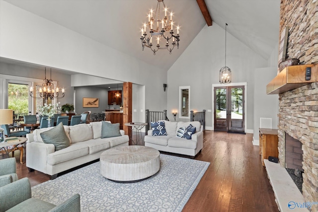 living room with an inviting chandelier, dark hardwood / wood-style floors, a healthy amount of sunlight, and a fireplace