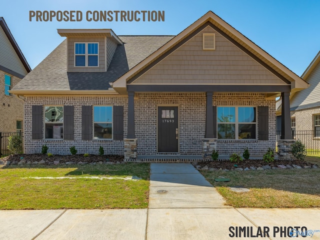 craftsman house featuring a front yard and covered porch