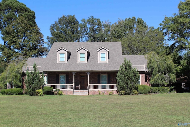 new england style home with a front lawn and a porch