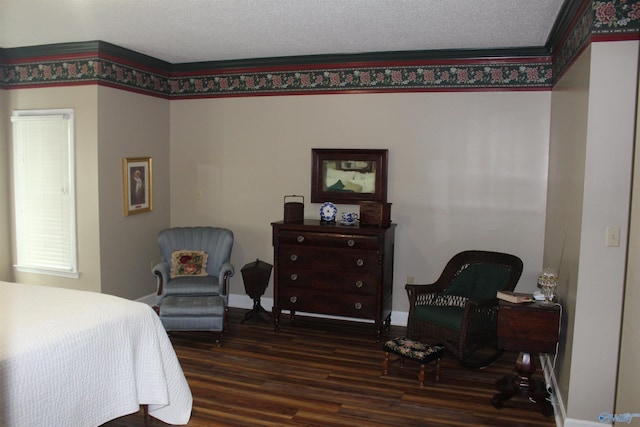 bedroom with a textured ceiling, crown molding, and dark wood-type flooring