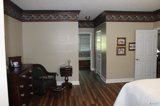 bedroom featuring ensuite bathroom, a textured ceiling, and dark hardwood / wood-style flooring