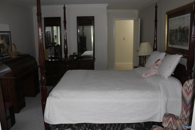 bedroom with ornamental molding and carpet flooring