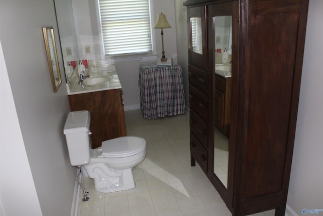 bathroom with toilet, tile patterned flooring, and vanity