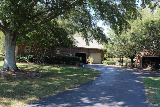 view of front of house featuring a garage and a front lawn