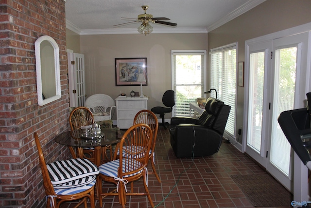 dining area with ceiling fan, crown molding, and brick wall