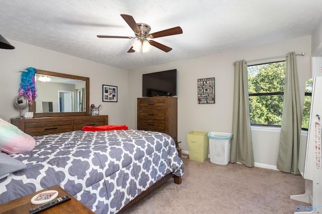 carpeted bedroom with a textured ceiling and ceiling fan