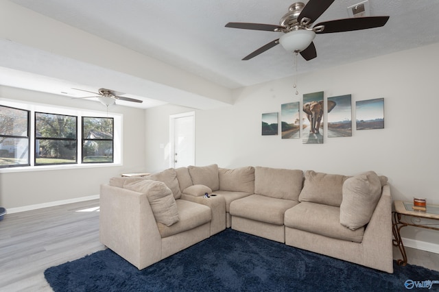 living room featuring ceiling fan and wood-type flooring