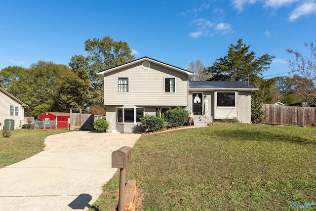 tri-level home featuring central AC and a front yard