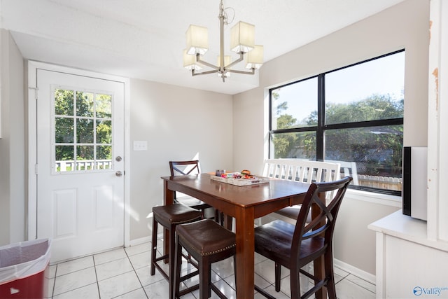 tiled dining area with a notable chandelier