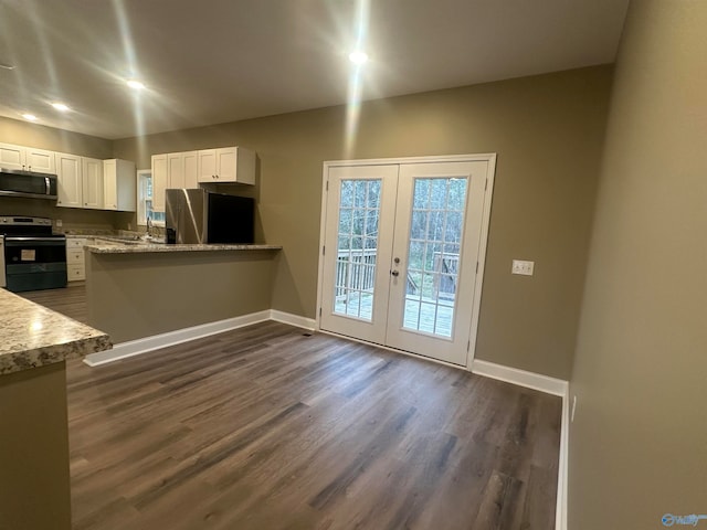 kitchen with dark hardwood / wood-style floors, french doors, stainless steel appliances, and white cabinets