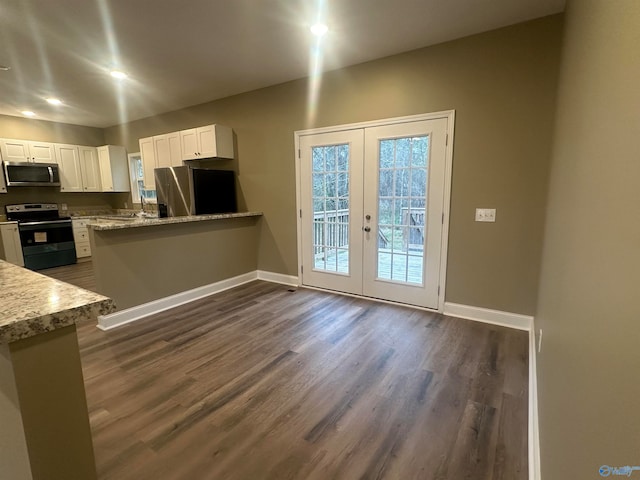 kitchen featuring white cabinets, dark wood-type flooring, french doors, and appliances with stainless steel finishes