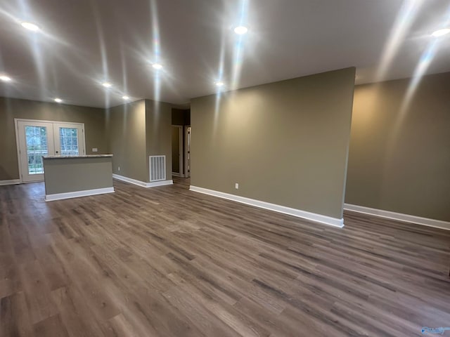 basement featuring dark hardwood / wood-style flooring and french doors