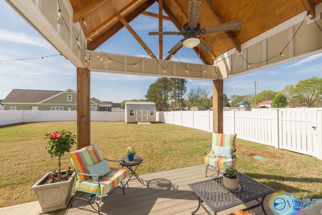 23276 Saint John Rd, Athens, AL 35613 - wooden deck featuring an outbuilding, a fenced backyard, a storage unit, ceiling fan, and a yard
