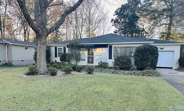 single story home with a front yard and a garage