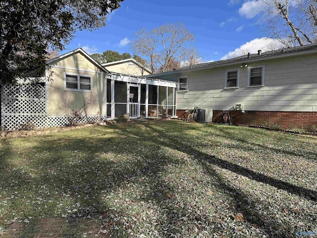 back of house featuring a yard, central AC, and a sunroom