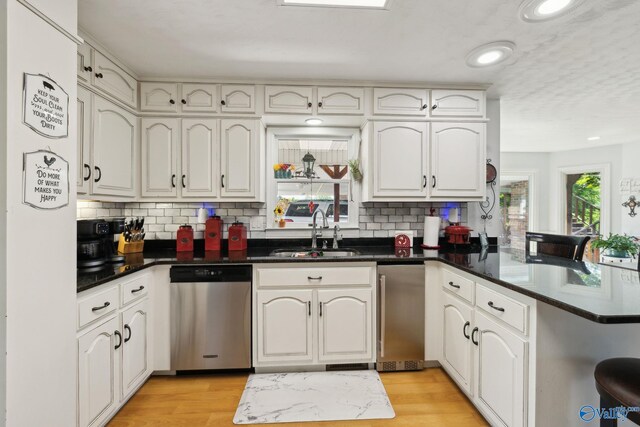 7734 Upper Snake Rd, Athens, AL 35614 - kitchen featuring a sink, a peninsula, dishwasher, and a wealth of natural light