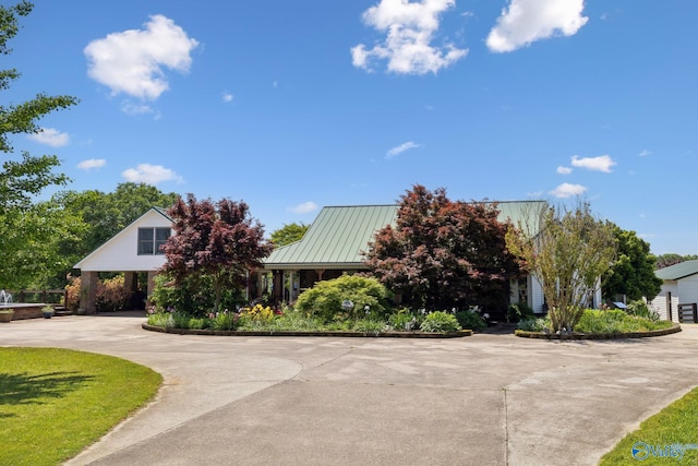 7734 Upper Snake Rd, Athens, AL 35614 - view of front of home featuring curved driveway, metal roof, and a standing seam roof