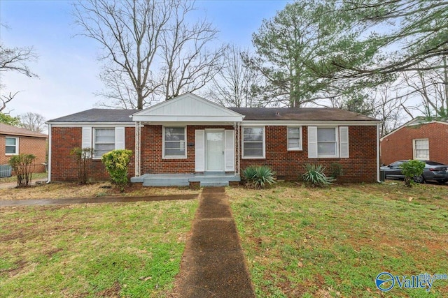 view of front of home with a front yard and brick siding