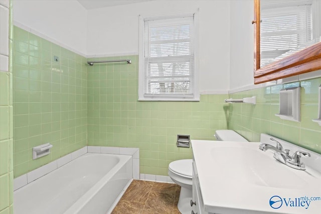 bathroom with toilet, tile walls, and vanity